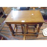 A nest of three polished oak tea tables, set on turned supports