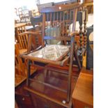 A pair of antique stained beech framed folding stick back elbow chairs with upholstered seat
