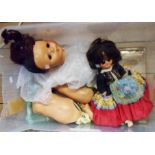 A crate containing two vintage dolls - one for restoration