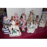 A collection of small Staffordshire and other figurines including German match striker, box