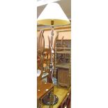 A 20th Century stained wood standard lamp with shade, part reeded pillar and circular base, set on