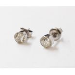 A pair of high carat white metal diamond stud ear-rings - each stone 4.5mm diameter