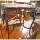 A 23" Edwardian stained wood two tier occasional table with moulded shaped surfaces, set on