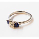 A hallmarked 950 (platinum)ring, set with central diamond and flanking sapphires