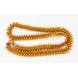 An ornate unmarked yellow metal beaded link choker necklace with replacement clasp