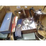 A box containing boxed and loose silver plated cutlery, two basting spoons, photograph frame and