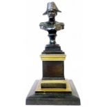 A small bronze bust of Napoleon set on a bronze and brass plinth base