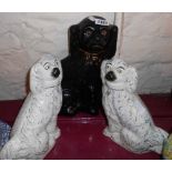 A pair of Staffordshire spaniels and a large black pottery similar