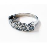 A marked 750 white metal five stone collar set diamond ring