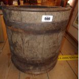 An old coopered wooden bucket with iron handle
