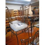 A set of six modern cast metal framed stick back dining chairs with antiqued finish and