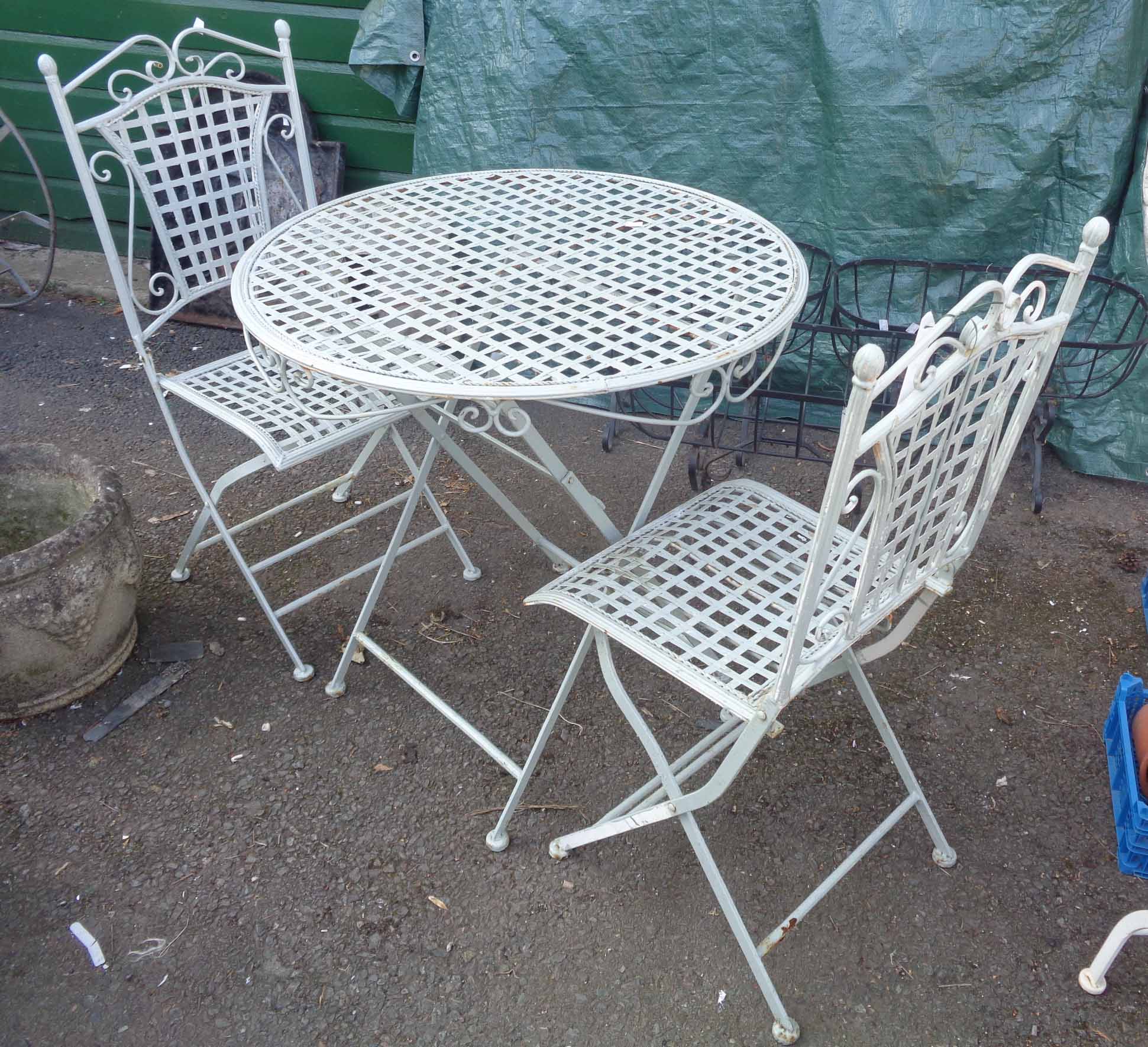 A cast and wrought metal garden table and two chairs