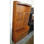 A 3' 4 1/2" Nathan Furniture cabinet with shelf, pair of glazed panel doors and recess over pair