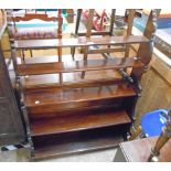 A 36" Victorian style stained wood five shelf open waterfall bookcase, set on a acanbus scroll