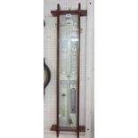 A reproduction stained oak Gothic style cased Admiral Fitzroy barometer with printed backboard,