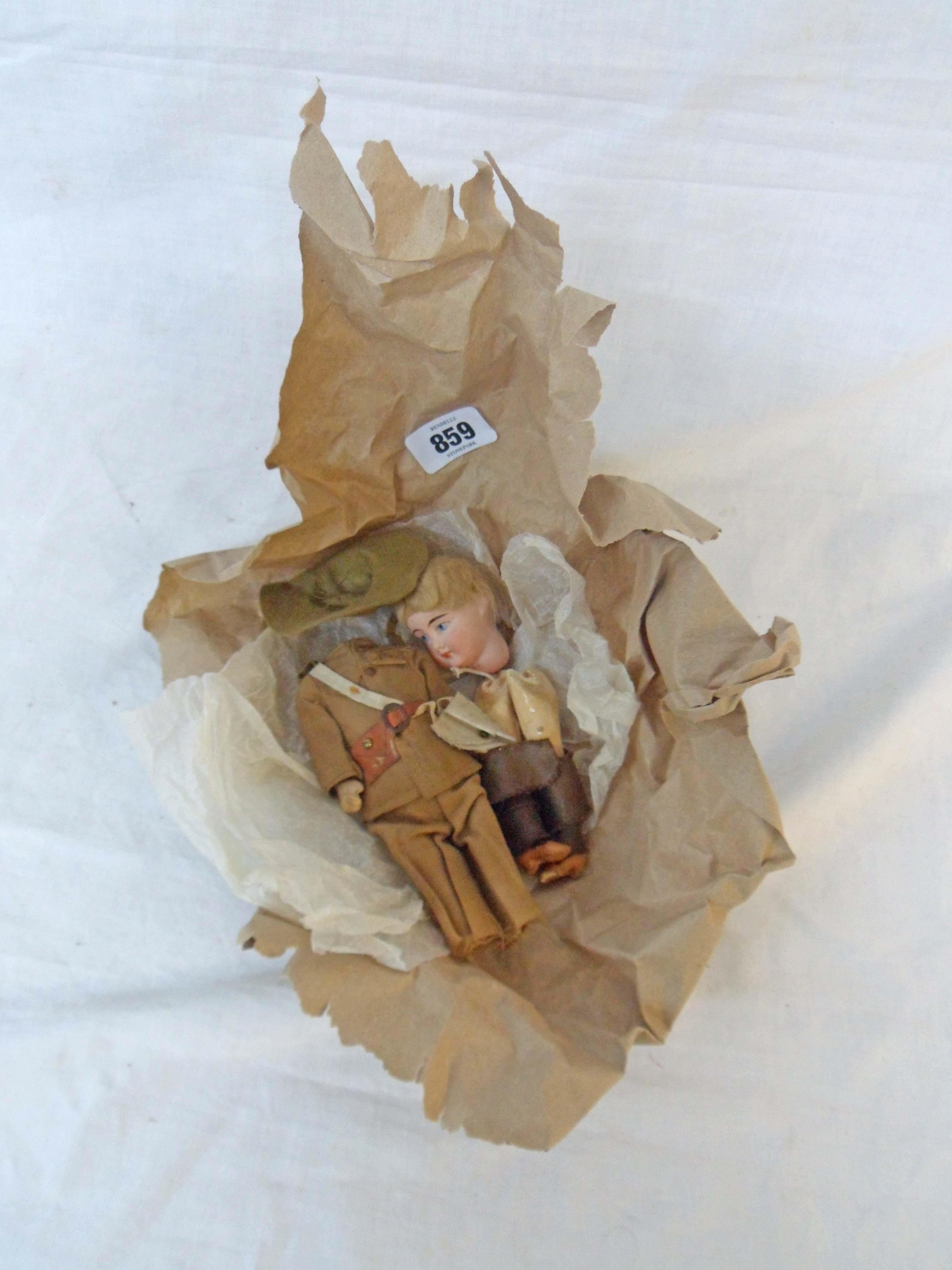 A German porcelain headed doll with composite limbs and wearing a bespoke First World War Australian