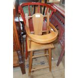 A red stained wood child's bow high chair with solid elm seat - sold with a doll's highchair with