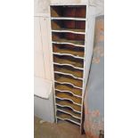 A 16 3/4" vintage painted pine filing unit with flight of twelve shaped shelves - some damaged -