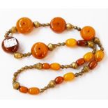 A chunky amber bead necklace with brass spacers including reused honey and yellow amber beads