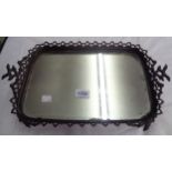 An antique heavy cast rustic pattern tea tray with mirror insert base, set on branch pattern feet