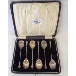 A cased set of six silver coffee spoons with cast terminals - Birmingham 1926
