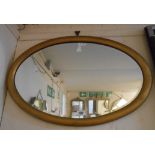 A framed oval mirror