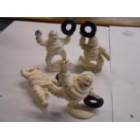 Four small reproduction painted cast metal Michelin men