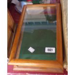 A small glazed table top display case