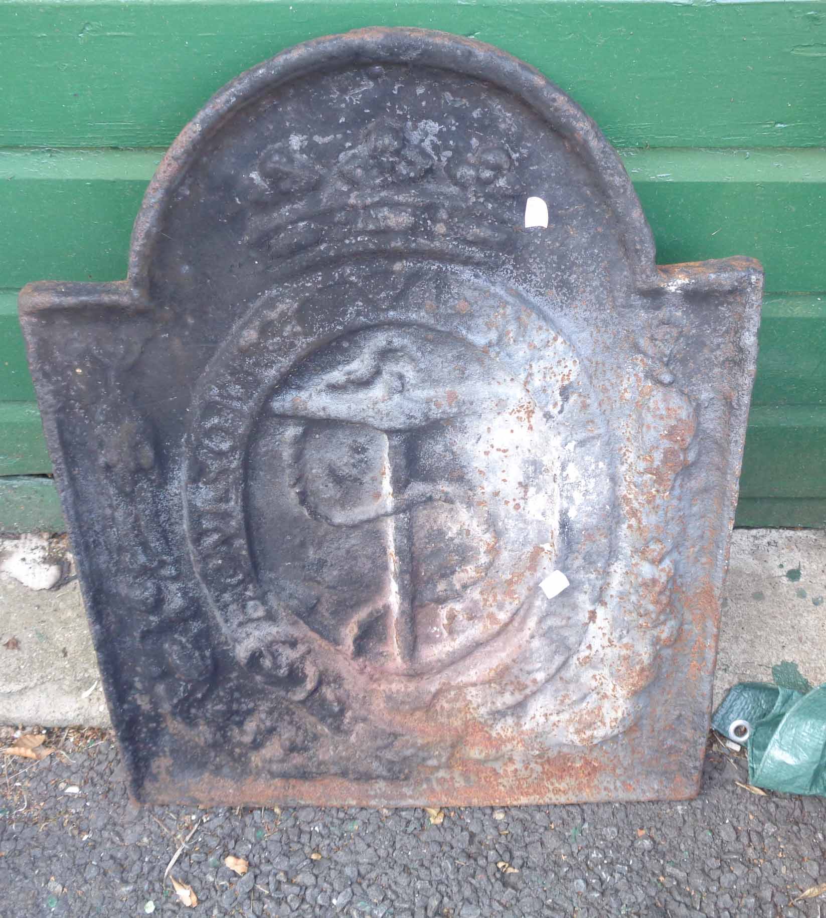 An old cast iron fire back with moulded anchor decoration