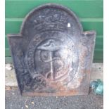 An old cast iron fire back with moulded anchor decoration