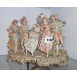 A late 19th Century porcelain continental figure group depicting five people in period dress - minor