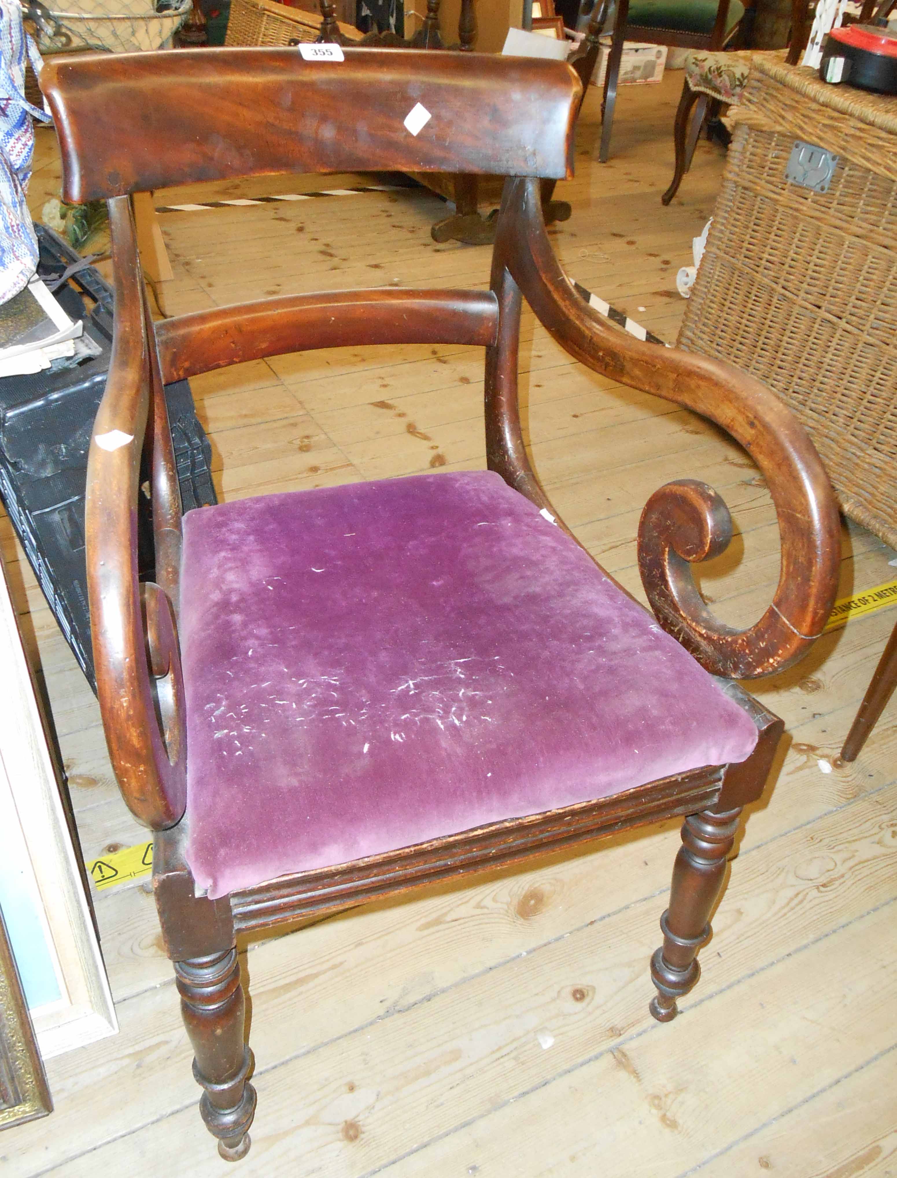 A 19th century mahogany framed open scroll elbow chair with upholstered drop-in seat, set on