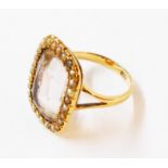 A marked 15ct yellow metal dress ring, set with large oblong pale amethyst stone within a seed pearl