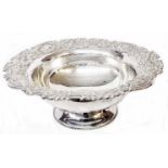 A 11 3/4" diameter Anglo-Indian marked "silver" pedestal bowl with embossed floral scroll decoration