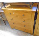 A 35 1/2" polished light oak and mixed wood chest of two short and three long drawers, set on