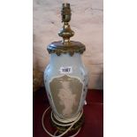A large Limoges style table lamp with pate-sur-pate oriental figure, monogrammed TP, with brass
