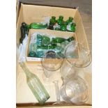 A quantity of green glass chemist's bottles, ink bottles, measuring jars, etc.