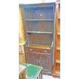 A 29" late Victorian stained oak book cabinet with two adjustable shelves, long freze drawer and