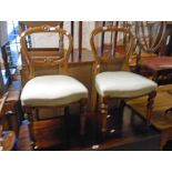 A pair of Victorian mahogany framed balloon back dining chairs with incised and carved decoration,