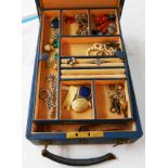 A vintage blue leather clad jewellery box containing a yellow metal mourning locket, single string