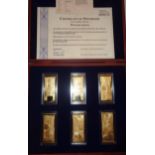 A cased set of commemorative bank notes A cased set of encapsulated cast metal commemorative bank