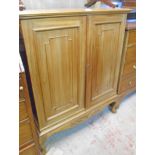 A 34" mahogany two door cabinet with converted interior for media use, set on acanthus cabriole legs