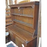 A 5' 20th Century oak two part dresser with central pillar to the two shelf open plate rack over a