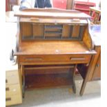 A 30" early 20th Century oak tambour fronted roll-top desk with part fitted interior and single