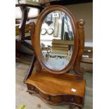 An Eastern hardwood platform dressing table mirror with bevelled oval plate and three drawers to