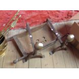A pair of Arts & Crafts movement wrought iron and hand beaten brass andirons marked for BWS and a