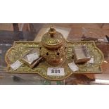 A Victorian embossed and pierced brass inkstand and two chrome plated travelling inkwells