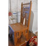 A 20th Century olive wood Islamic standard chair with intricate spindle panels, solid seat and