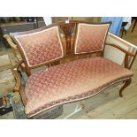 A 4' 5" Edwardian inlaid walnut show frame two seater settee with central decorative splat, flanking