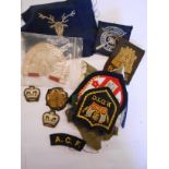 A bag containing assorted military and other embroidered patch badges